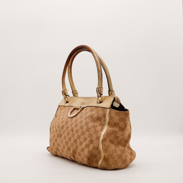 Vue de trois quarts Tote Gucci monogramme et cuir métallisé doré — AMANA Vintage