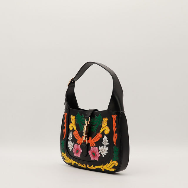 Sac Gucci Jackie cuir noir fleurs peintes vue de trois quarts occasion authentique — AMANA Vintage