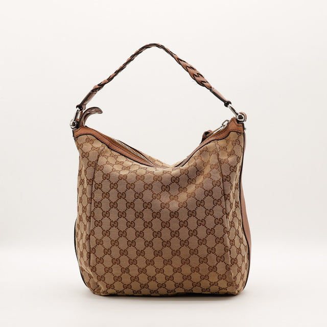 Détail des coins inférieurs Gucci Hobo toile monogrammée beige et ébène occasion authentique — AMANA Vintage