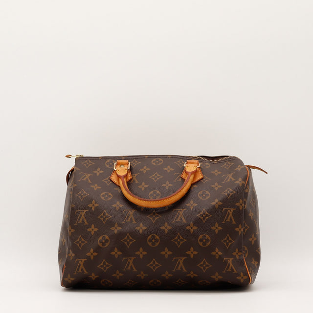 Détail des anses Louis Vuitton Speedy 30 cuir vachette caramel occasion authentique — AMANA Vintage