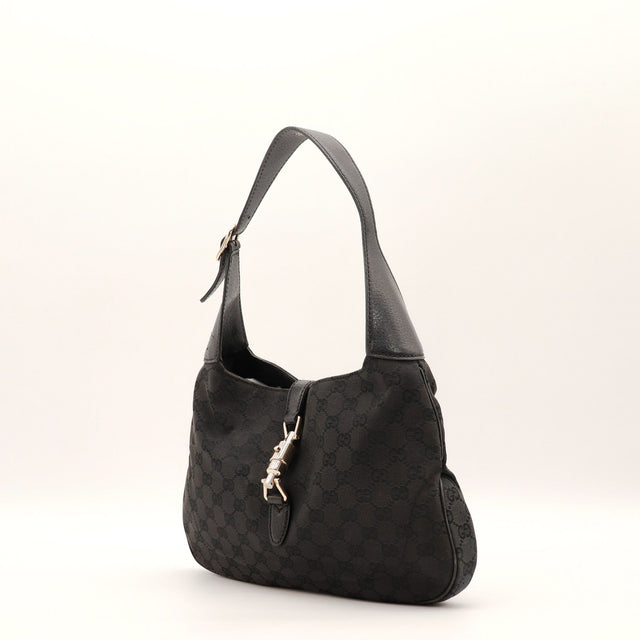 Détail fermoir piston doré Gucci Jackie noir occasion authentique — AMANA Vintage