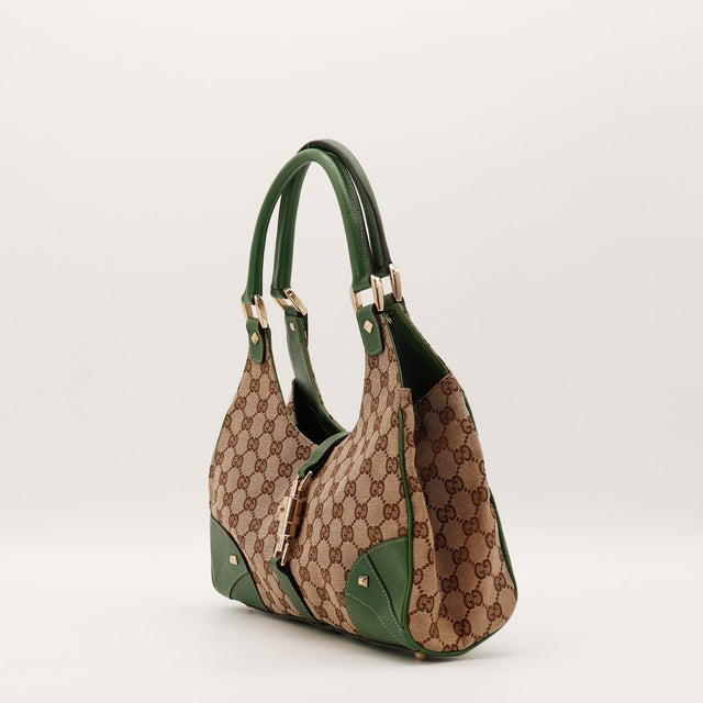 Détail fermoir piston doré Gucci Jackie occasion authentique — AMANA Vintage