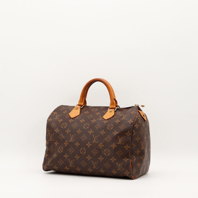 Louis Vuitton Speedy 30 vue trois quarts gauche toile Monogramme patine caramel — AMANA Vintage