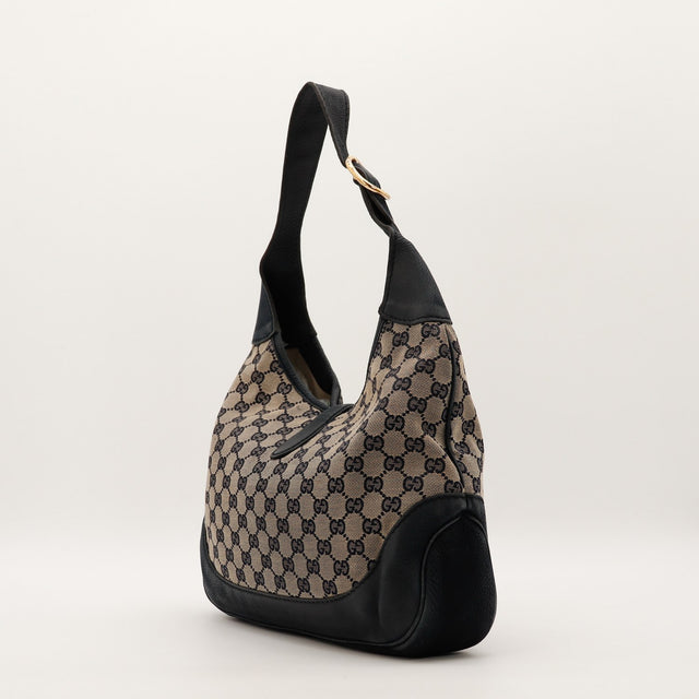 Vue de profil côté gauche Gucci New Jackie toile monogrammée cuir noir fond — AMANA Vintage