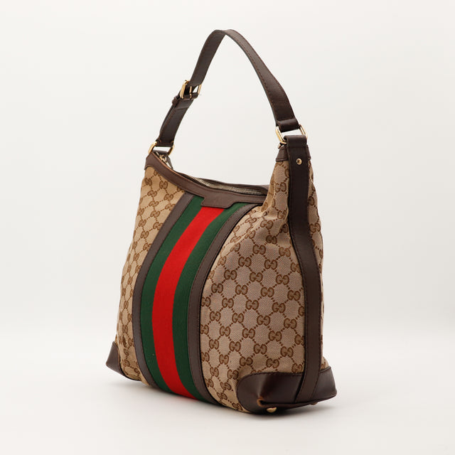 Gucci Hobo Web GG Canvas vue trois quarts gauche bande Web occasion — AMANA Vintage