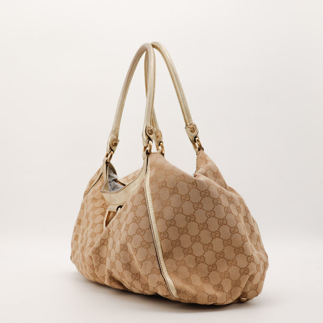 Sac Gucci Hobo toile monogrammée vue de trois quarts occasion authentique — AMANA Vintage