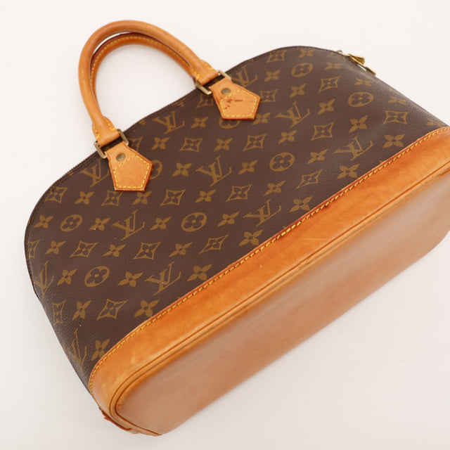 Détail base cuir et toile Monogramme Louis Vuitton Alma PM — AMANA Vintage