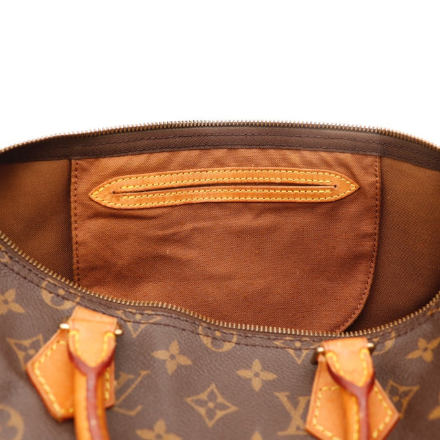 Détail des anses en cuir vachette Louis Vuitton Speedy 35 Toile Monogramme occasion authentique — AMANA Vintage