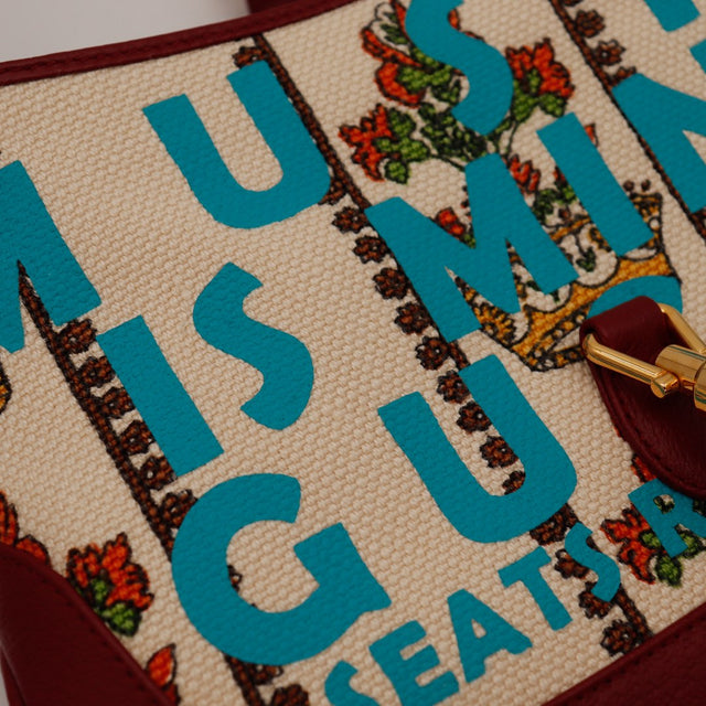Détail canvas Gucci New Jackie Music Is Mine impression typographique turquoise couronnes florales — AMANA Vintage