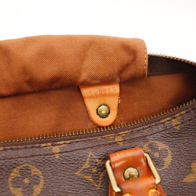 Détail des anses Louis Vuitton Speedy 30 cuir vachette caramel occasion authentique — AMANA Vintage