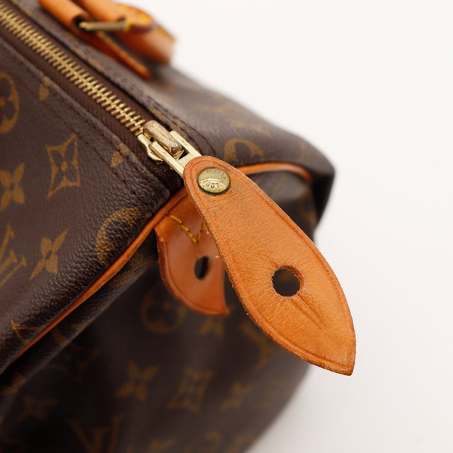 Detail bevestiging handvat vachettaleer Louis Vuitton Speedy 30 patine caramel — AMANA Vintage