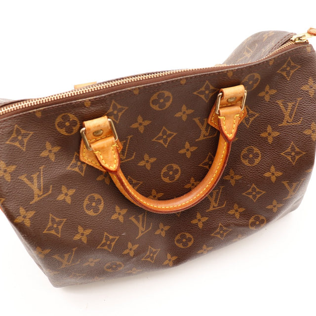 driekwartaanzicht handvatten Louis Vuitton Speedy 30 patine caramel vachette — AMANA Vintage