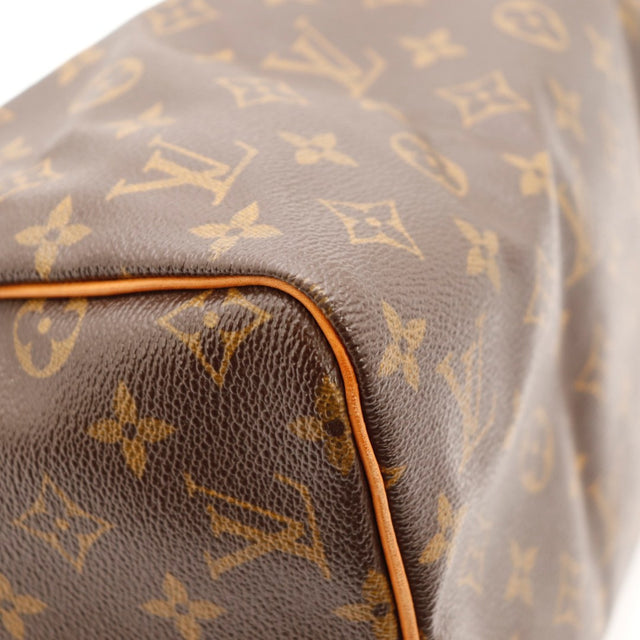 Détail du cadenas Louis Vuitton Speedy 30 argenterie dorée occasion authentique — AMANA Vintage