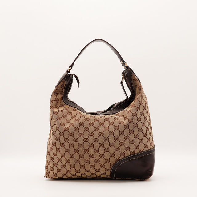 Détail du mors doré et du pompon en cuir Gucci Hobo Web — AMANA Vintage