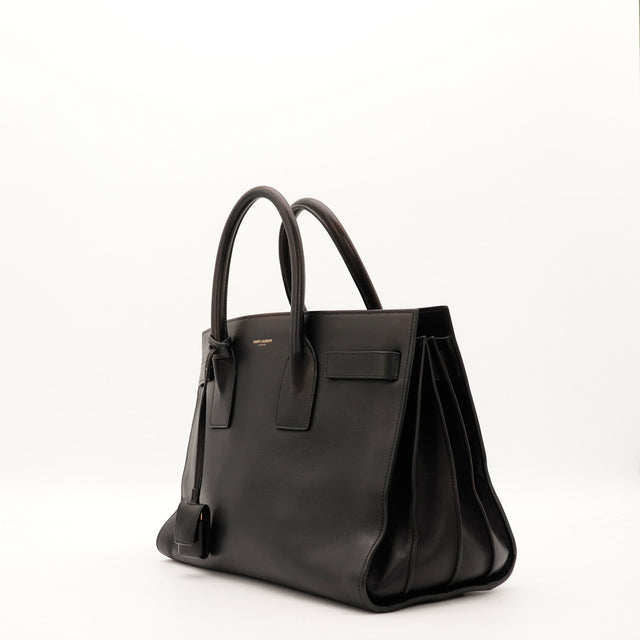 Sac Saint Laurent Sac de Jour Small noir vue de trois quarts avec soufflets accordéon — AMANA Vintage