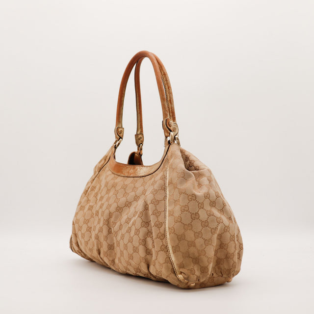 Sac Gucci Hobo toile monogrammée vue de profil occasion authentique — AMANA Vintage