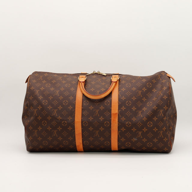 Louis Vuitton Keepall 55 vue de face côté anses cuir vachette caramel — AMANA Vintage