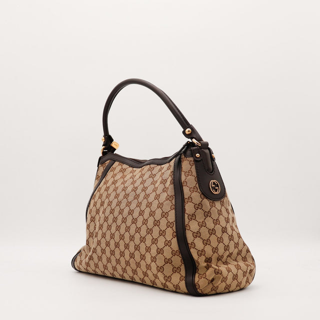 Hobo Gucci vue de trois quarts droite détail anse cuir marron occasion — AMANA Vintage