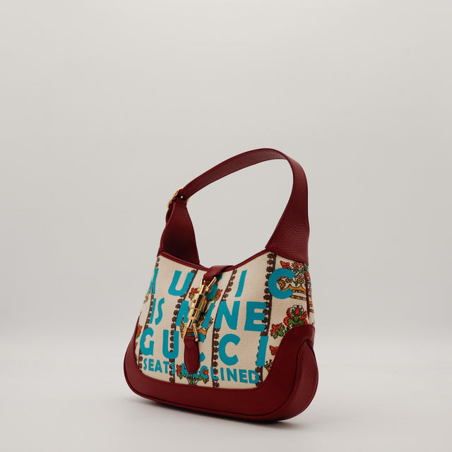 Gucci New Jackie Music Is Mine vue de trois quarts gauche cuir bordeaux fermoir piston doré — AMANA Vintage