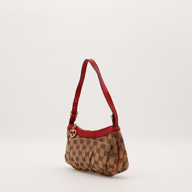 Pochette Gucci monogramme rouge vue de trois quarts gauche — AMANA Vintage