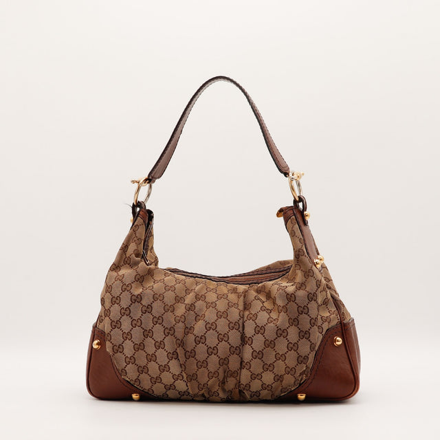 Détail des coins inférieurs Gucci Hobo toile monogrammée beige occasion authentique — AMANA Vintage