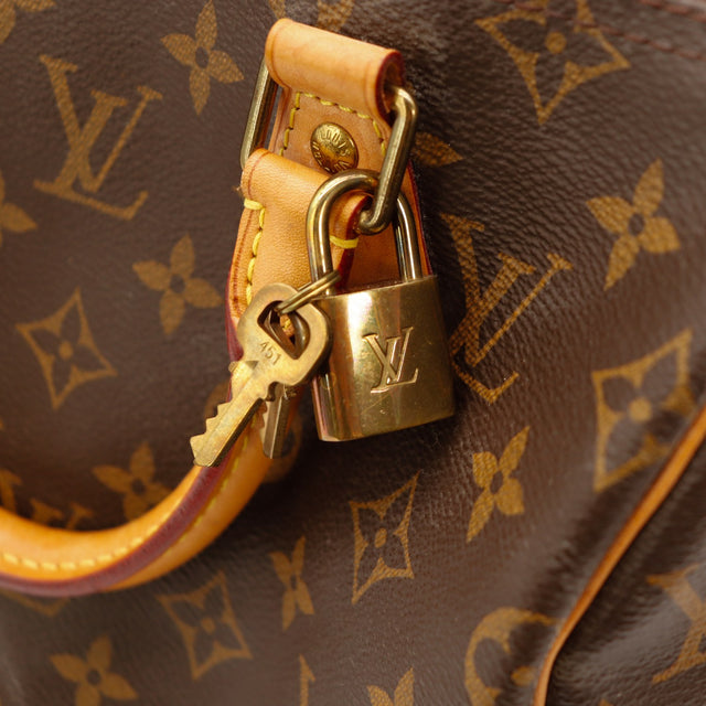 Détail cadenas doré et clé Louis Vuitton Speedy 25 — AMANA Vintage