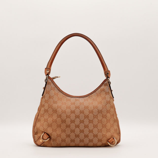 Détail de l'anse en cuir Gucci Hobo toile monogrammée marron occasion authentique — AMANA Vintage