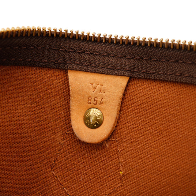 Détail zip et languette cadenas Louis Vuitton Speedy 30 cuir vachette caramel — AMANA Vintage