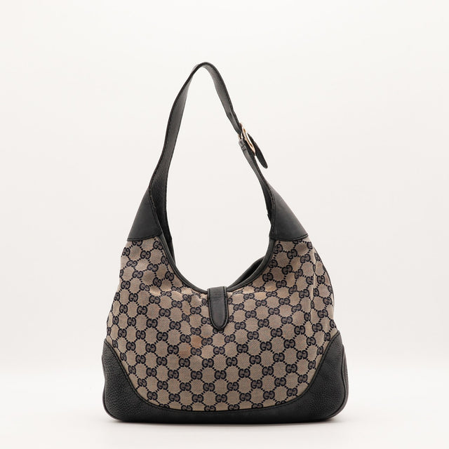 Détail du fermoir piston doré Gucci Jackie occasion authentique — AMANA Vintage