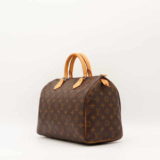 Sac Louis Vuitton Speedy 30 vue trois quarts cuir vachette patine caramel — AMANA Vintage