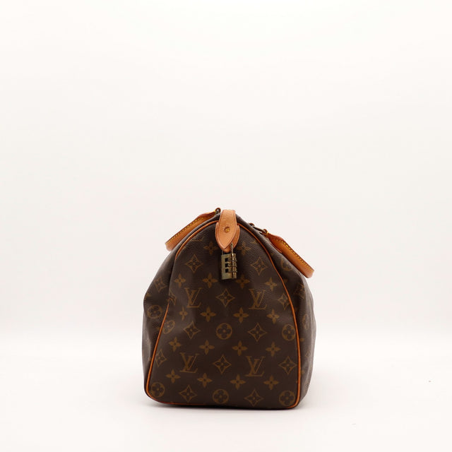 Profil gauche Louis Vuitton Speedy 35 cadenas à combinaison et languette cuir — AMANA Vintage
