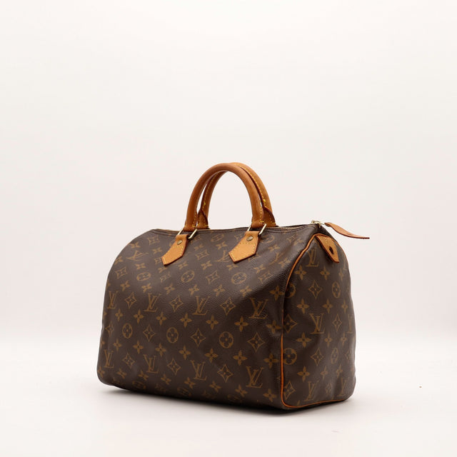 Louis Vuitton Speedy 30 vue trois quarts toile Monogramme anses vachette caramel — AMANA Vintage