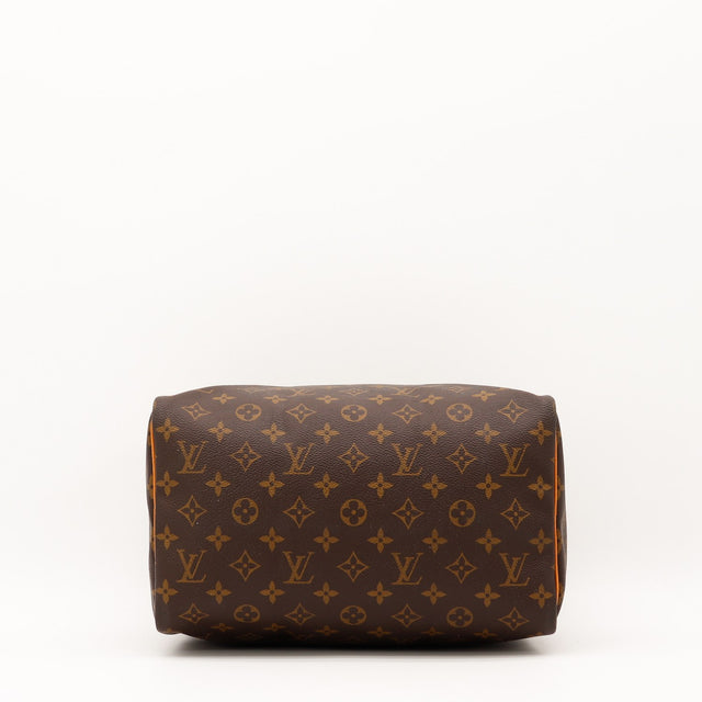 Détail des anses Louis Vuitton Speedy 30 cuir vachette patine caramel occasion authentique — AMANA Vintage