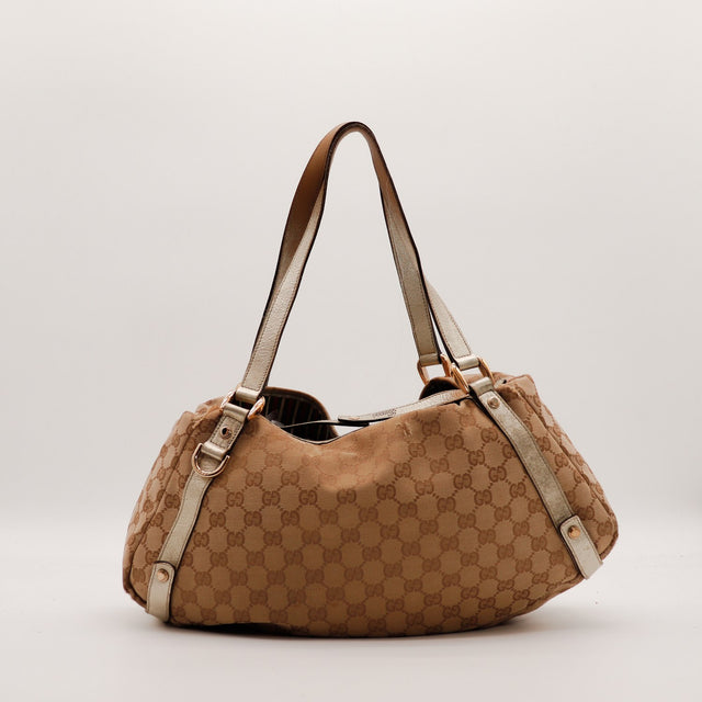 Hobo Gucci vue de côté droit toile monogrammée cuir doré — AMANA Vintage