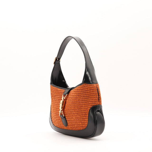 Detail fermoir piston doré Gucci Jackie 1961 raphia occasion authentique — AMANA Vintage