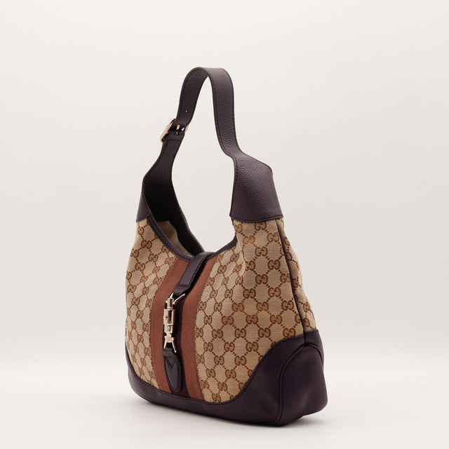 Détail fermoir piston doré Gucci Jackie occasion authentique — AMANA Vintage