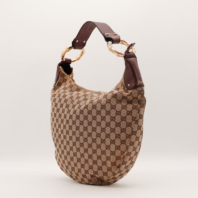 Détail anneaux bambou dorés Gucci Hobo toile GG beige occasion authentique — AMANA Vintage
