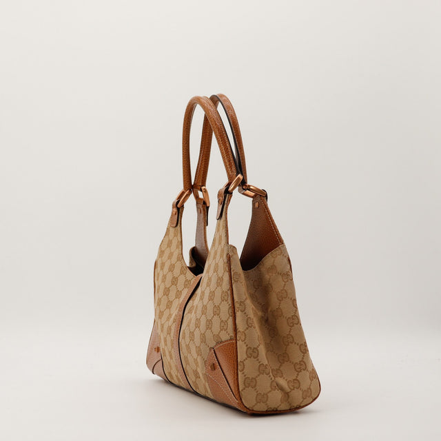 Vue de dessous Gucci New Jackie avec pieds dorés canvas GG occasion — AMANA Vintage