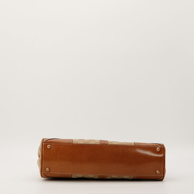 Détail fermoir Jackie cylindrique doré Gucci canvas GG vintage — AMANA Vintage