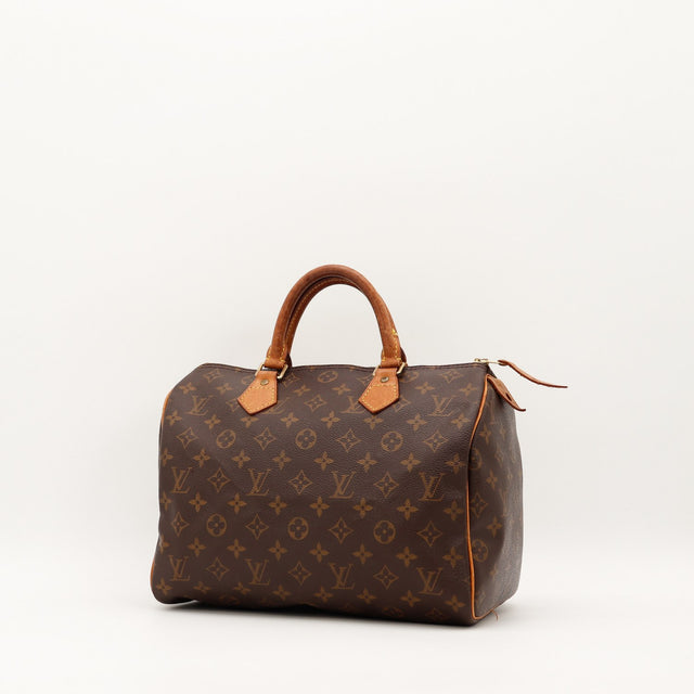 Louis Vuitton Speedy 30 vue trois quarts angle gauche toile monogramme patine caramel — AMANA Vintage