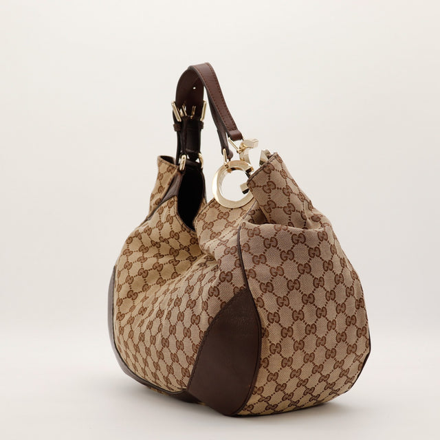 Gucci Hobo Interlocking G vue de trois quarts gauche anse cuir marron occasion authentique — AMANA Vintage