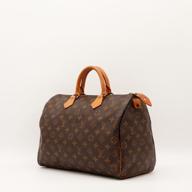 Détail cuir vachette patine caramel Louis Vuitton Speedy 35 occasion authentique — AMANA Vintage