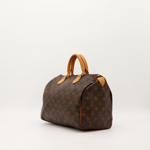 Détail coin et anse Louis Vuitton Speedy 30 patine caramel — AMANA Vintage