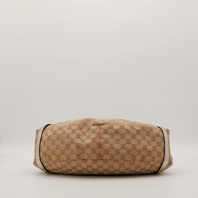 Détail canvas GG et anse cuir doré Gucci Hobo — AMANA Vintage