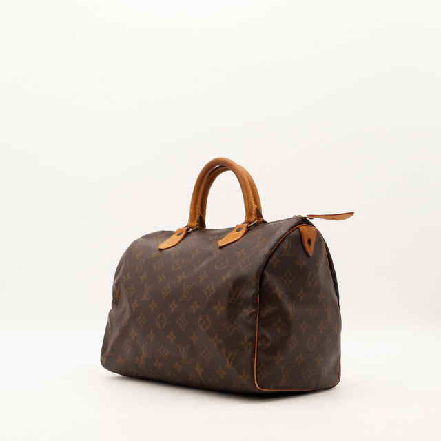 Louis Vuitton Speedy 30 vue trois quarts gauche toile monogrammée patine caramel — AMANA Vintage