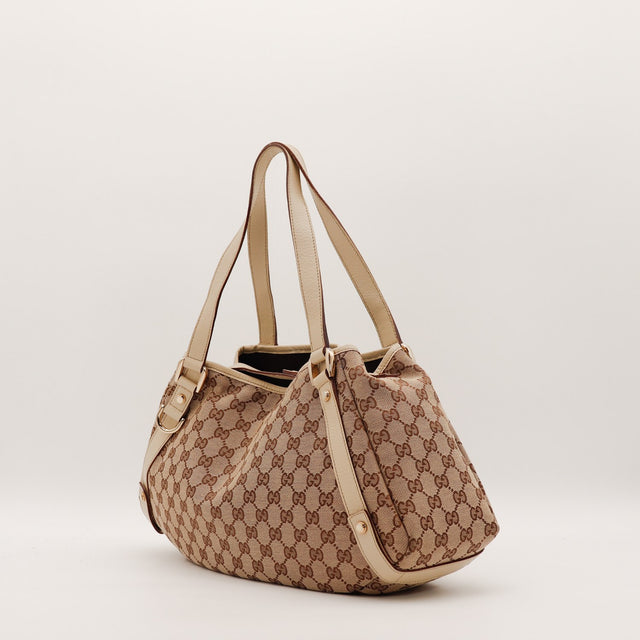 Hobo Gucci vue de trois quarts gauche toile monogrammée ivoire — AMANA Vintage