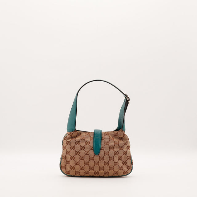 Détail du fermoir piston doré Gucci Jackie — AMANA Vintage