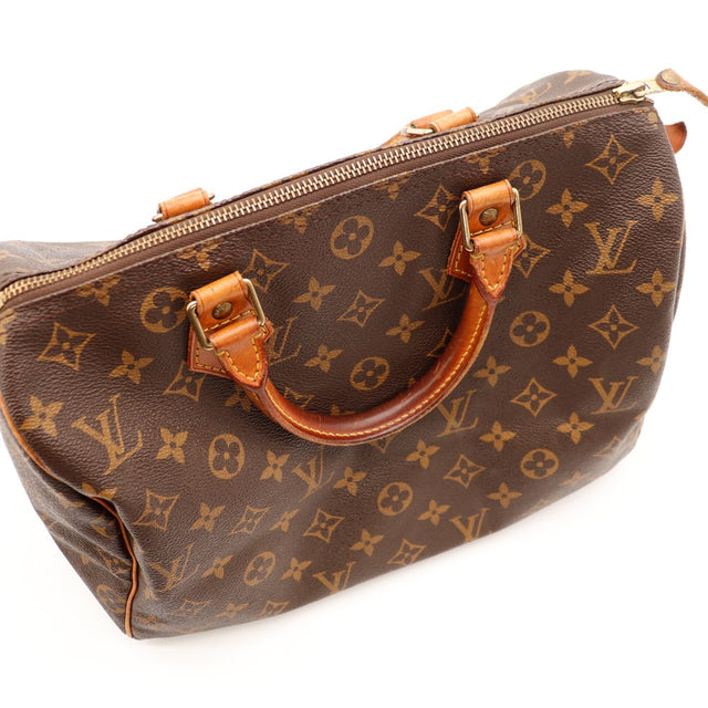 Détail anses Louis Vuitton Speedy 30 cuir vachette patine caramel foncée — AMANA Vintage
