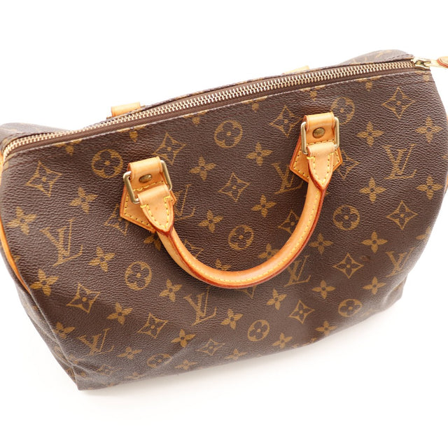 Détail anse cuir vachette patine caramel Louis Vuitton Speedy 30 — AMANA Vintage