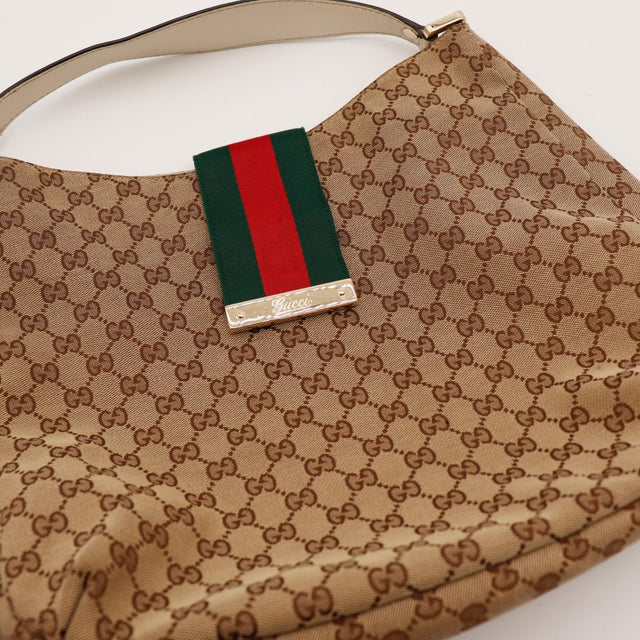 Detail bande Web et plaque métallique Gucci Hobo Web — AMANA Vintage